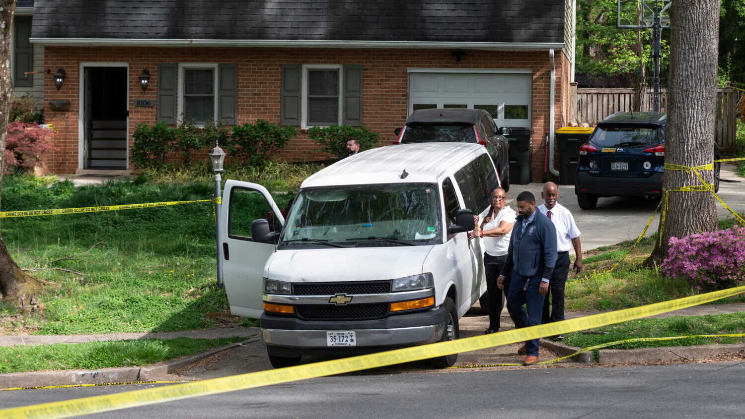Fairfax County coroners, with two bodies in the van, prepare to leave the home of former Virginia L...