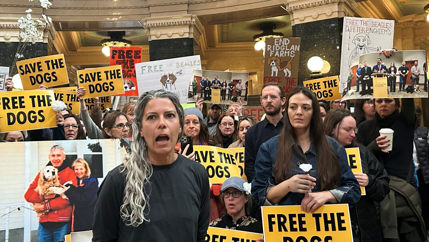 Rebekah Robinson, the president of Dane4Dogs, center left, speaks at a protest at the Wisconsin Sta...