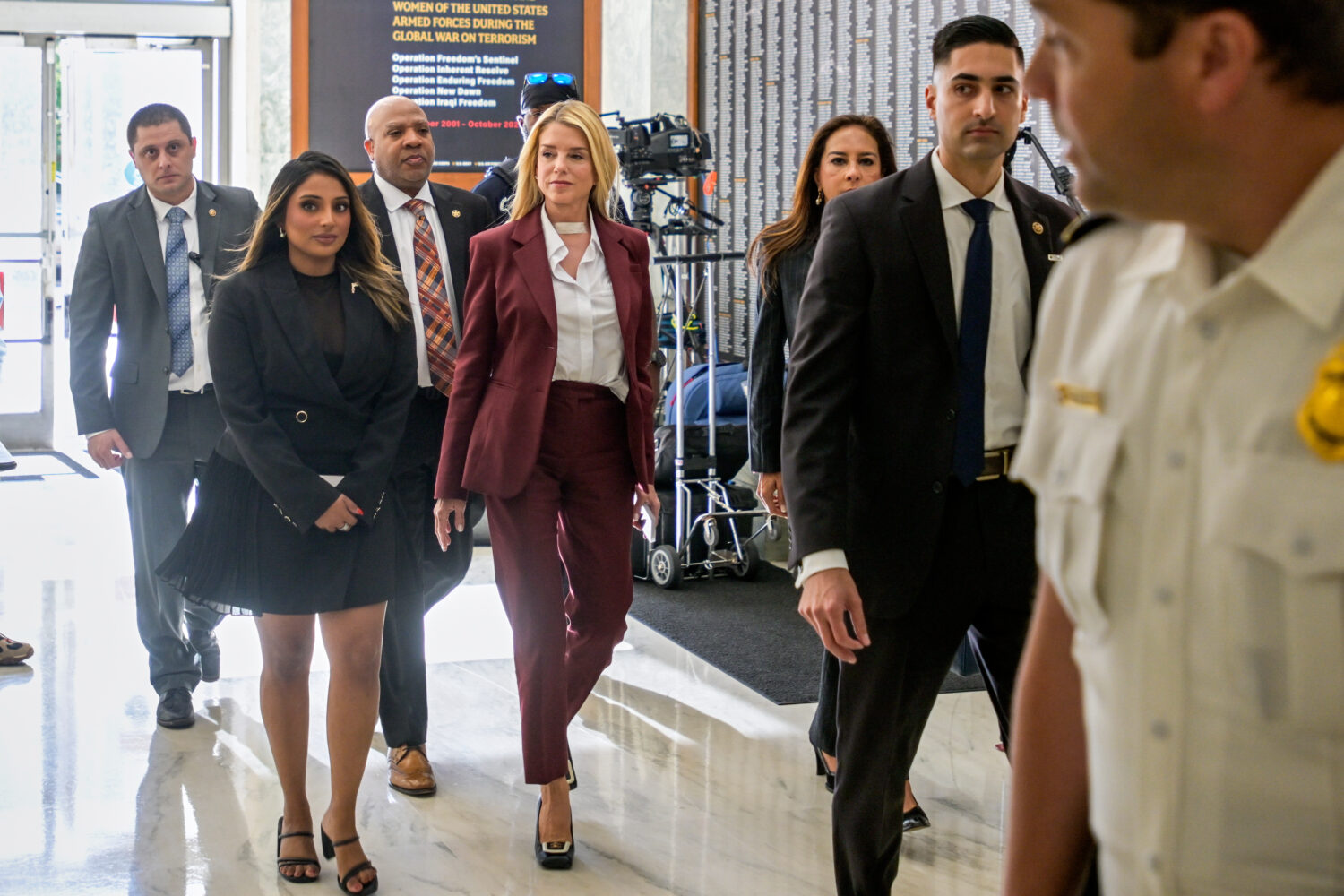 Former Attorney General Pam Bondi, center, arrives for her deposition at the Rayburn House Office B...
