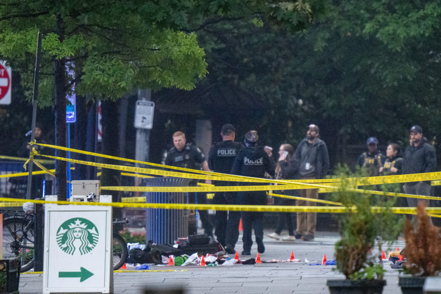 Emergency teams work the scene after multiple rapid-fire gunshots ring out near the White House on ...