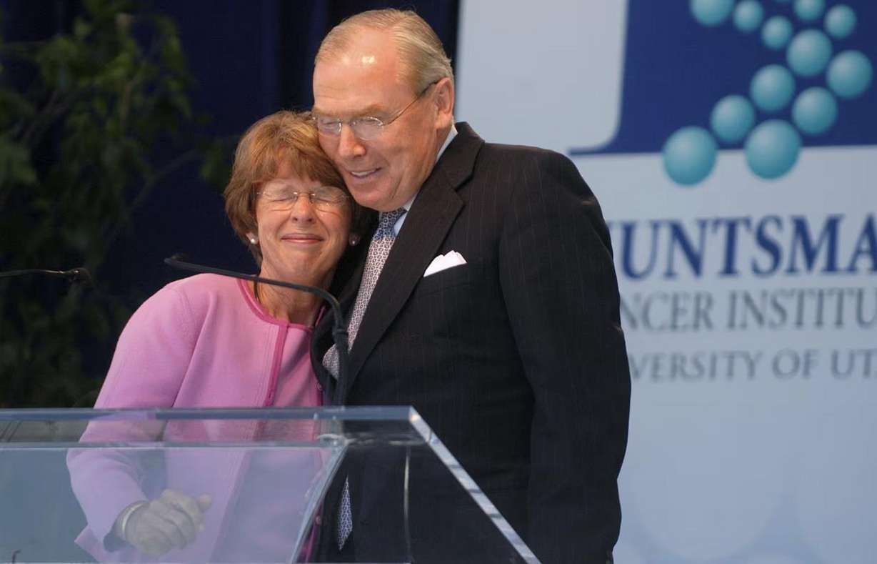 Karen Huntsman, left, embraces her husband Jon Huntsman Sr. following her remarks at the dedication of the new Huntsman Cancer Institute in Salt Lake City on Monday, June 21, 2004.