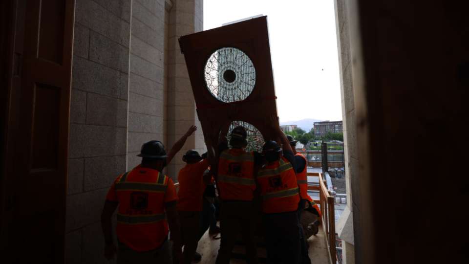 A crew of at least eight construction workers raises a side of the east temple doors during its reinstallment Tuesday at the Salt Lake Temple. (Photo: The Church of Jesus Christ of Latter-day Saints)