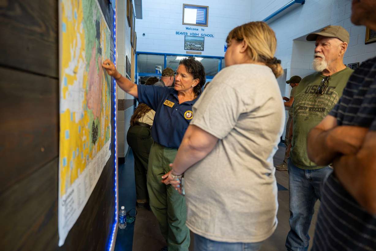 Public information officer Pattie Courtney talks with residents prior to a community meeting at Beaver High School about the Cottonwood Fire burning on the mountains east of Beaver on Monday. About one-third of the town's residents were at the meeting. (Photo: Scott G Winterton, Deseret News)