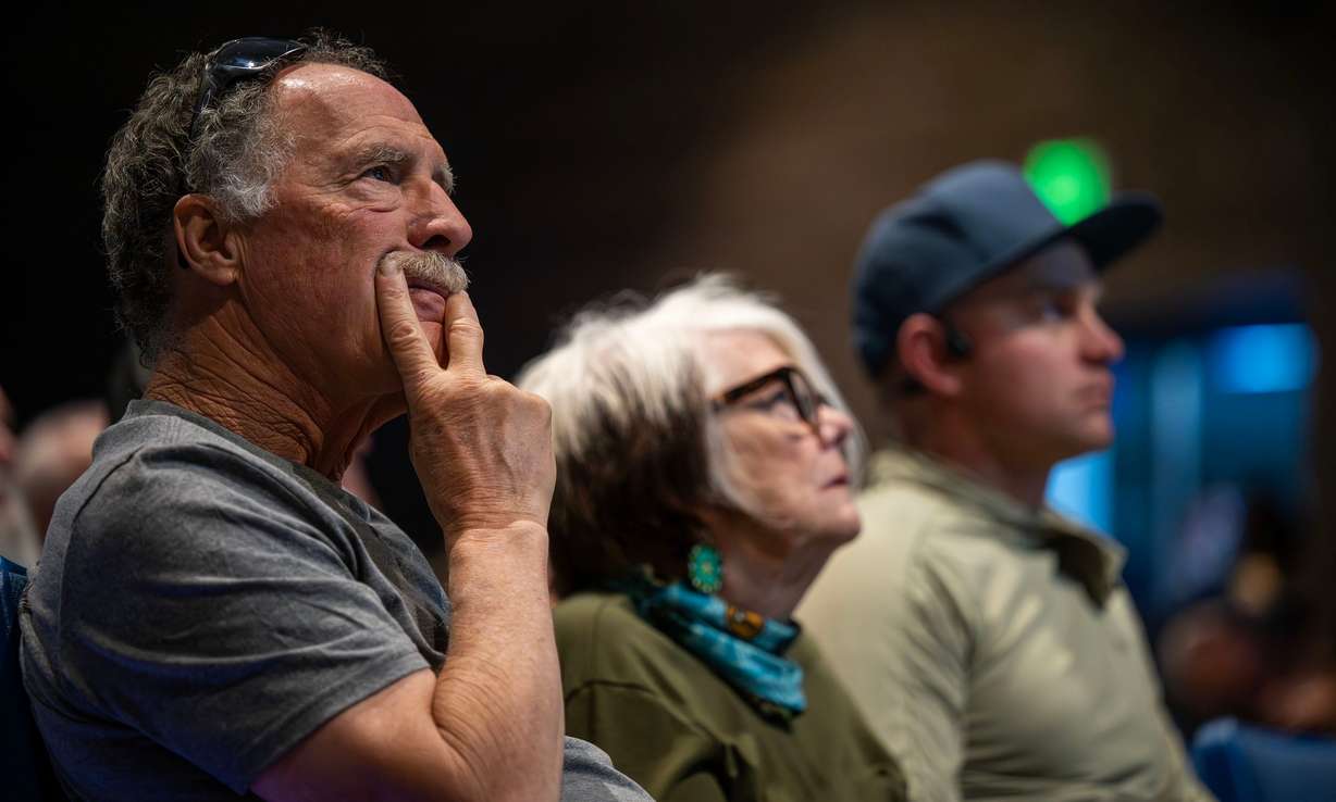 Lynn Jenkins, Pamela McCue and Tanner Larsen listen during a community meeting discussing the Cottonwood Fire burning on the mountains east of Beaver on Monday. The fire has torched over 94,000 acres and is just 4% contained. (Photo: Scott G Winterton, Deseret News)