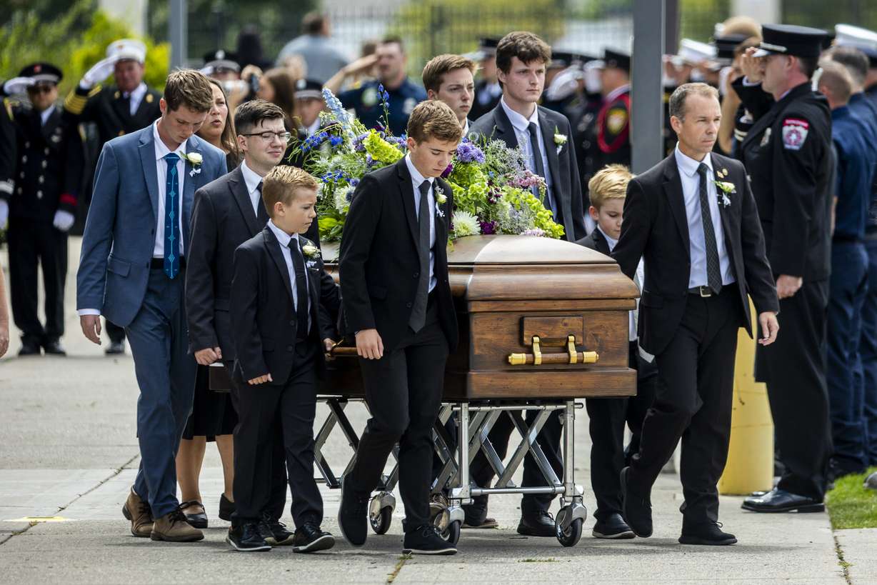 The casket of one of the three late Long family children is brought toward a hearse by pallbearers after the family’s funeral at the UCCU Center in Orem on Wednesday. The service was held for Long, his wife Katrina, and three of their four children — Reid, 20, Thayne, 13, and Gage, 12 — who all died in a flash flood in Wayne County on July 17. (Photo: Isaac Hale, Deseret News)