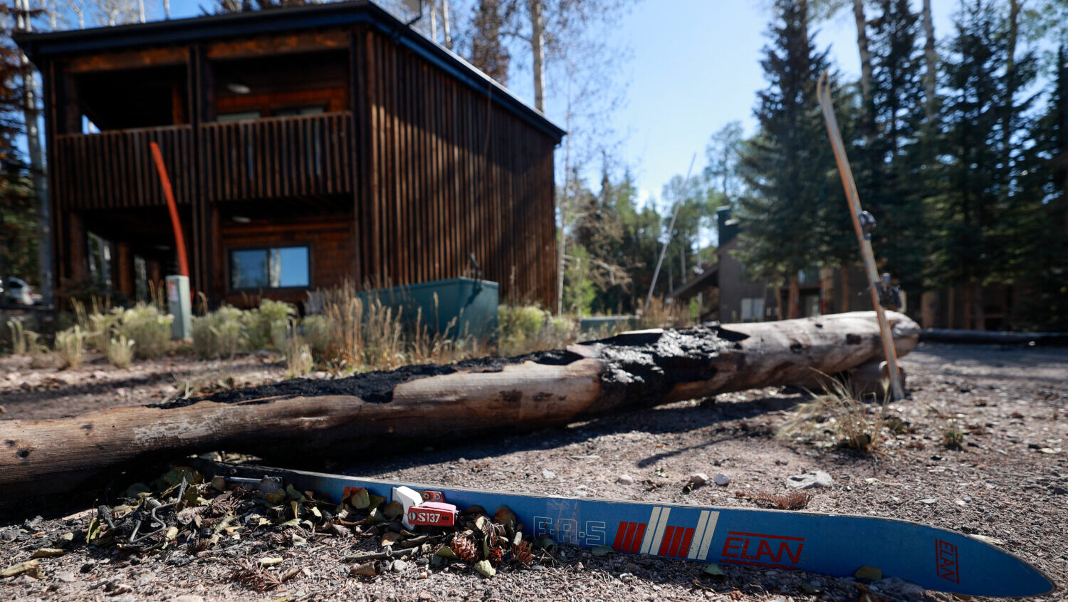 A charred ski is pictured in front of housing that survived the Cottonwood Fire at Eagle Point Ski Resort in Beaver County on Thursday, July 9, 2026. (Kristin Murphy, Deseret News)