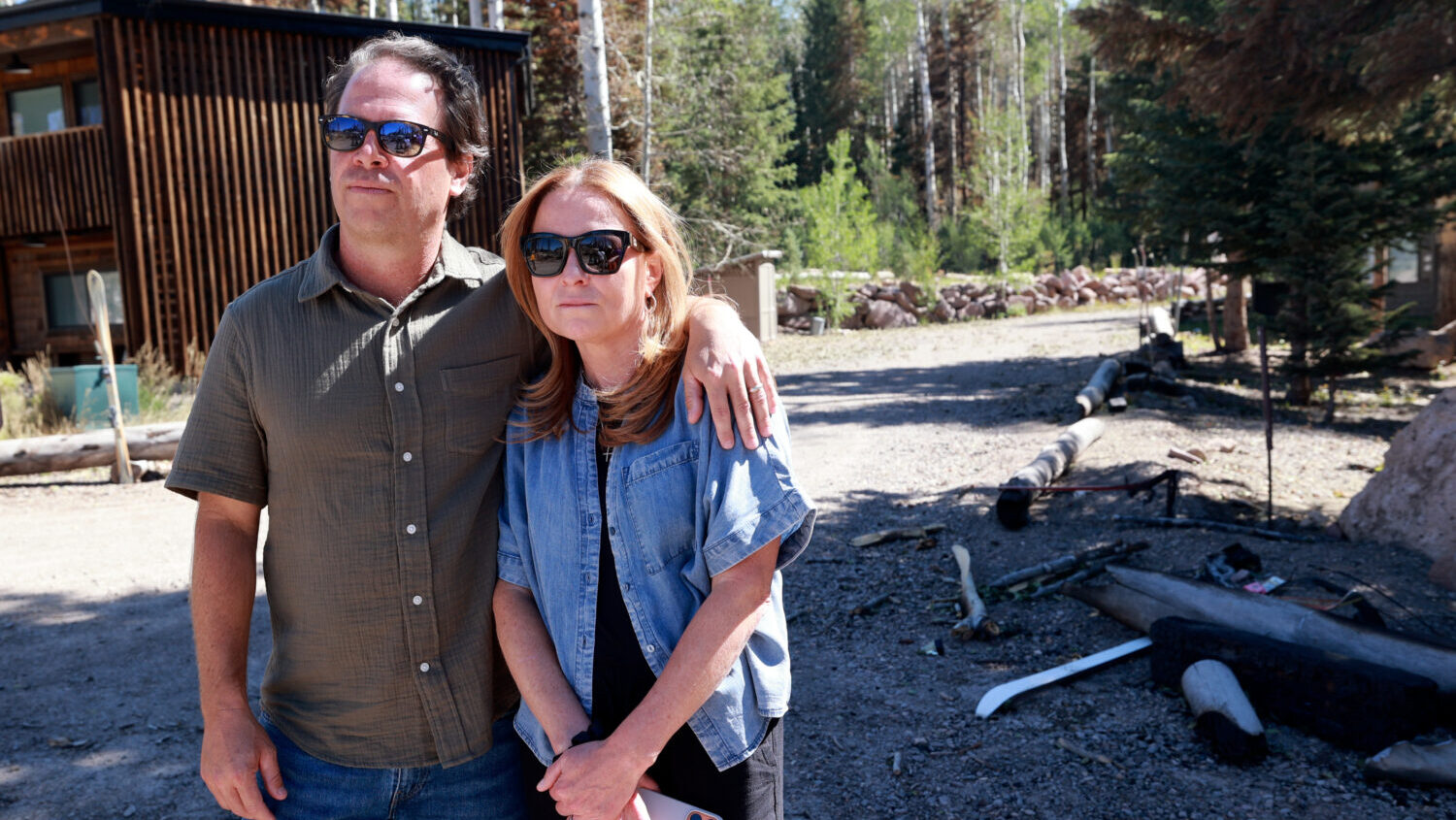 Shane and Kini Gadbaw, Eagle Point Ski Resort owners, embrace as they listen to an interview with a Fish Lake National Forest agency administrator at Eagle Point Ski Resort in Beaver County on Thursday, July 9, 2026. The Cottonwood Fire damaged much of the resort. (Kristin Murphy, Deseret News)