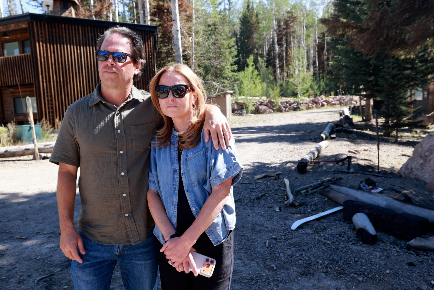 Shane and Kini Gadbaw, Eagle Point Ski Resort owners, listen to an interview with a Fish Lake National Forest agency administrator at Eagle Point Ski Resort in Beaver County on Thursday, July 9, 2026. The Cottonwood Fire damaged much of the resort. (Kristin Murphy, Deseret News)