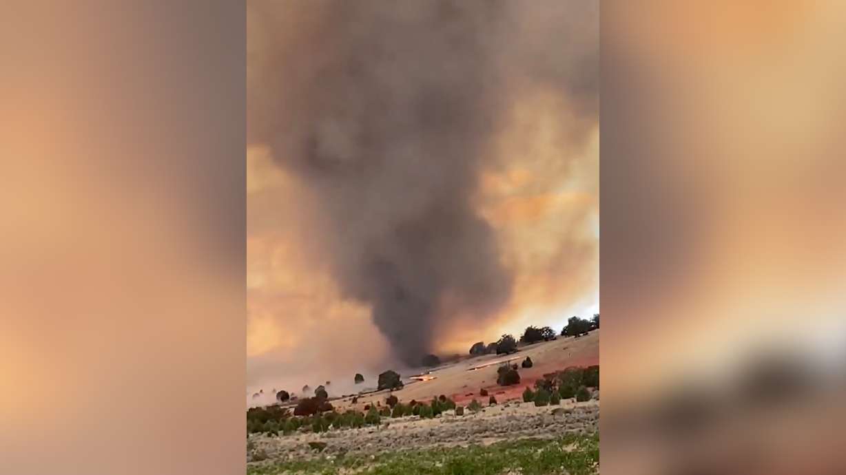 A fire-induced tornado, or firenado, spins through Millard County after forming within the Widemout...