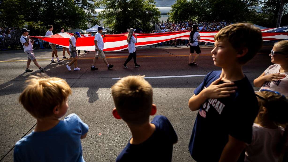 Brigham Holmstrom, 10, places his hand on his heart as the American flag is carried in the Freedom Festival Parade in Provo on July 4, 2025. The festival is set to return for America's 250th anniversary this weekend. (Photo: Tess Crowley, Deseret News)