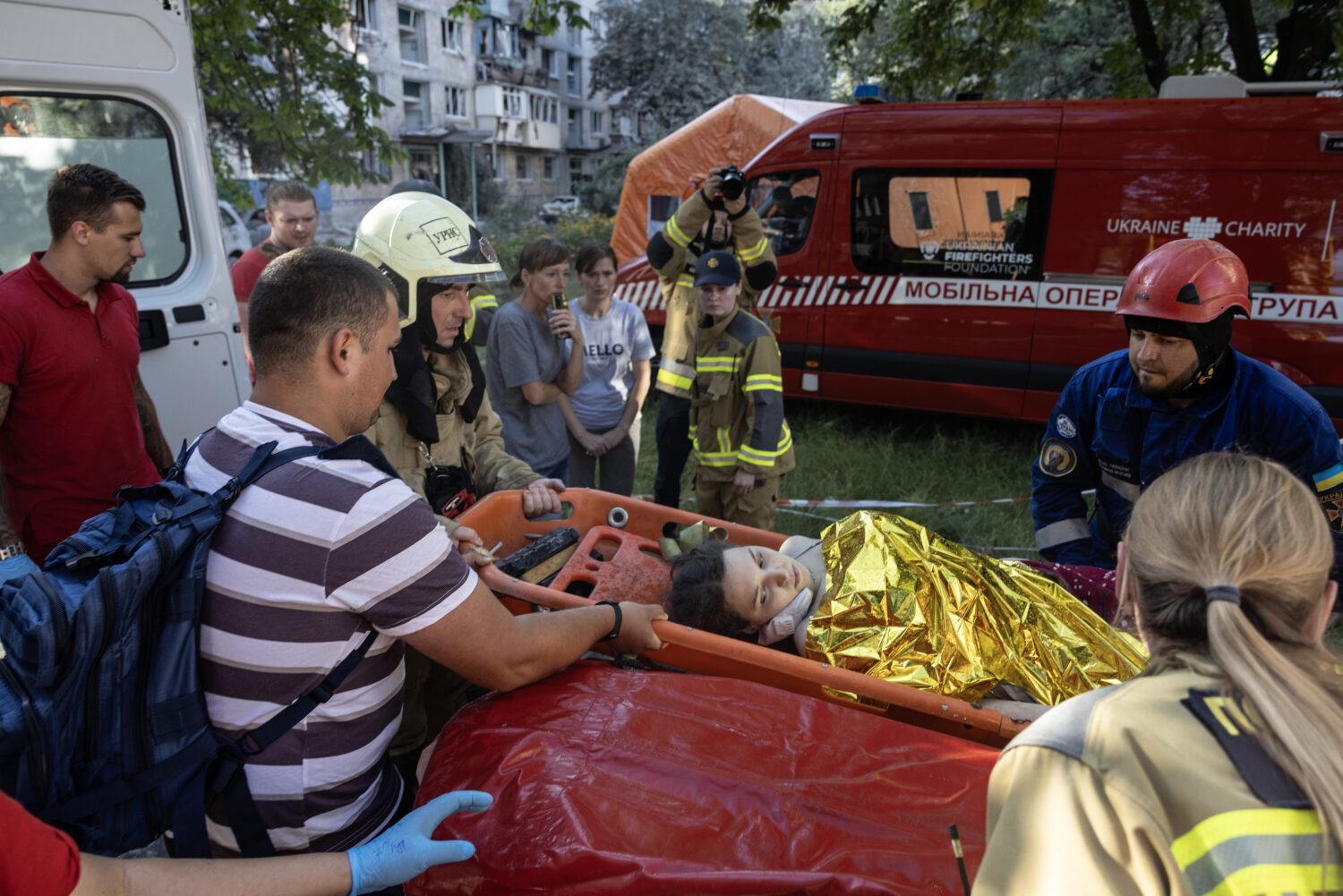 KYIV, UKRAINE - JULY 2: Emergency workers carry an injured woman to the ambulance from a collapsed residential building after a drone and missile attack by Russian forces on July 2, 2026 in Kyiv, Ukraine. The attack hit multiple buildings in different neighborhoods of the Ukrainian capital, leaving at least 17 dead, according to early statements from Ukrainian authorities. (Paula Bronstein, Getty Images)