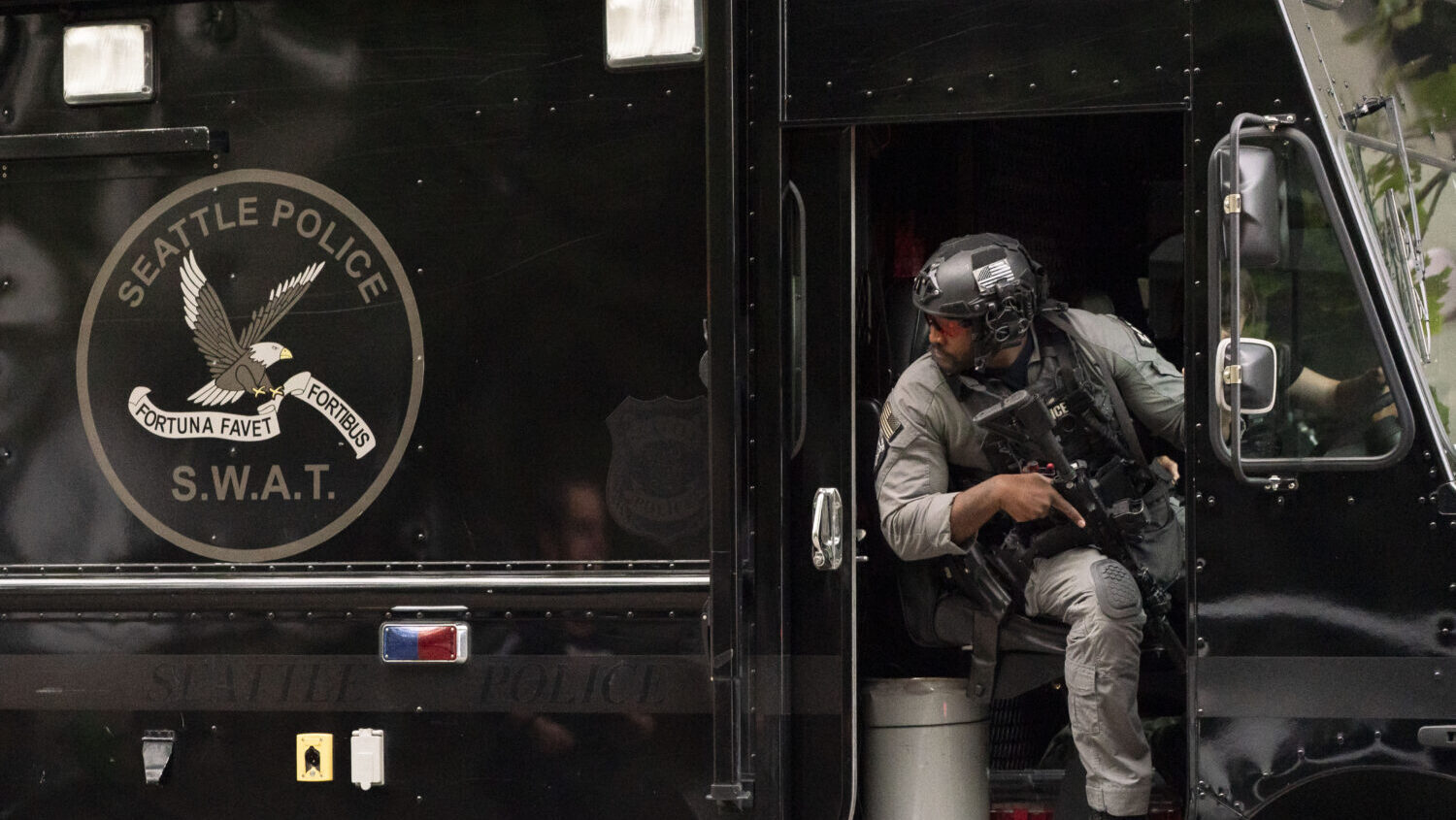 A member of the Seattle Police S.W.A.T. team looks out of his vehicle after a shooting at the Bite of Seattle food festival on July 26, 2026 in Seattle, Washington. Three people are dead and multiple people are wounded. Seattle mayor Katie Wilson said one suspect is in custody. (David Ryder, Getty Images)