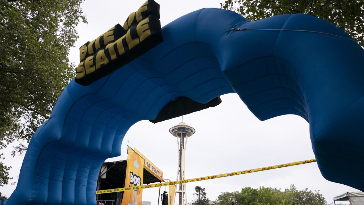 Caution tape cordons off an event entrance following a mass shooting at the Bite of Seattle food festival on July 26, 2026 in Seattle, Washington. At least two people are dead and at least five are wounded after a mass shooting at the event at Seattle Center. (David Ryder, Getty Images)