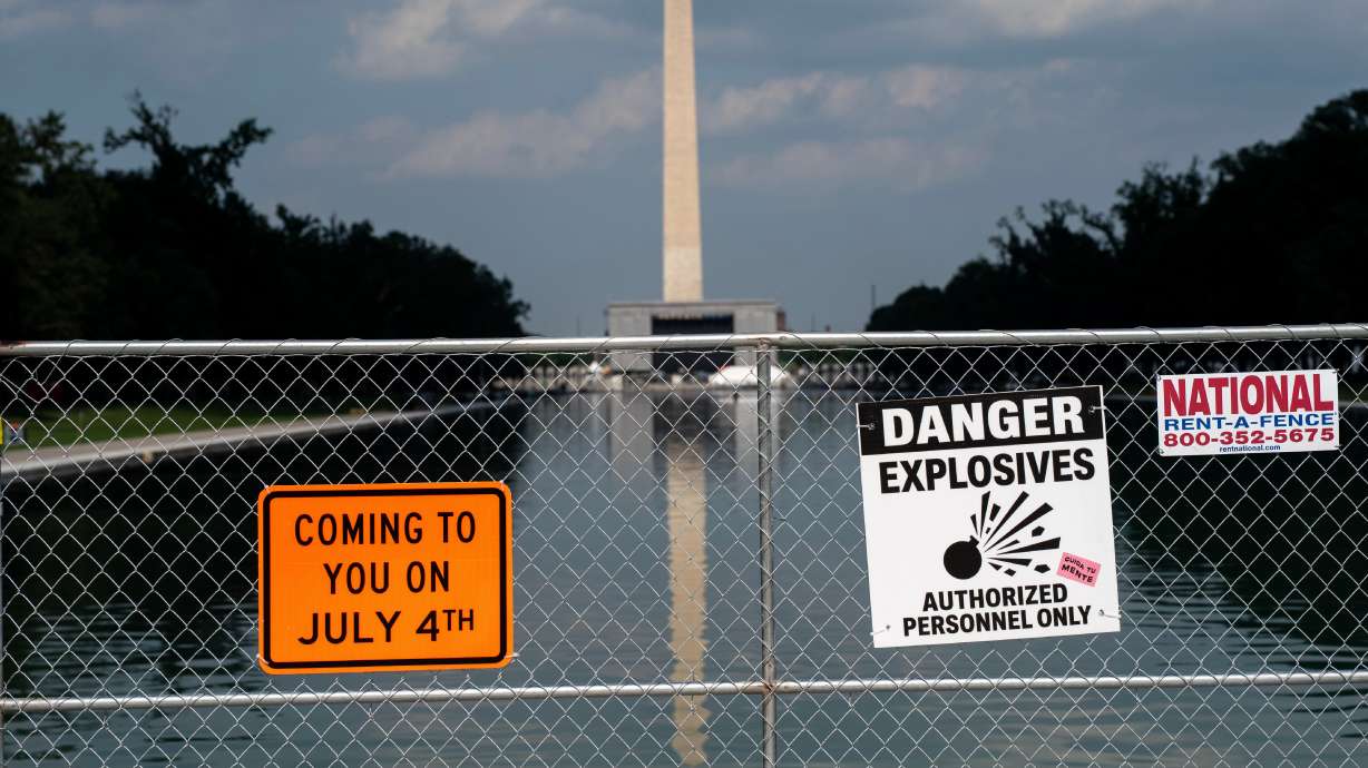 Signage and security fencing warns of explosives along the Lincoln Memorial Reflecting Pool ahead o...