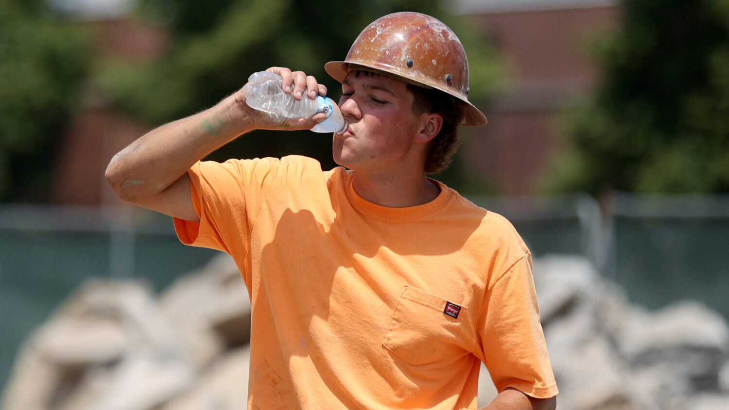 Camden Meekem takes a water break while working on a water main during a heat wave in Salt Lake Cit...