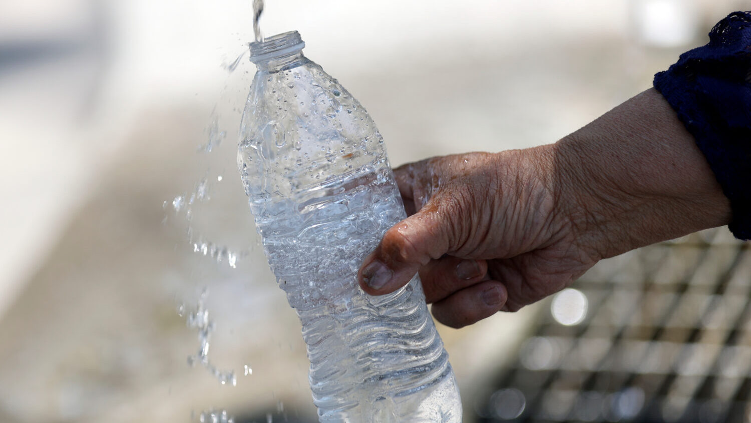 Lata Blake fills a water bottle at the Artesian Well Park during a heat wave in Salt Lake City on M...