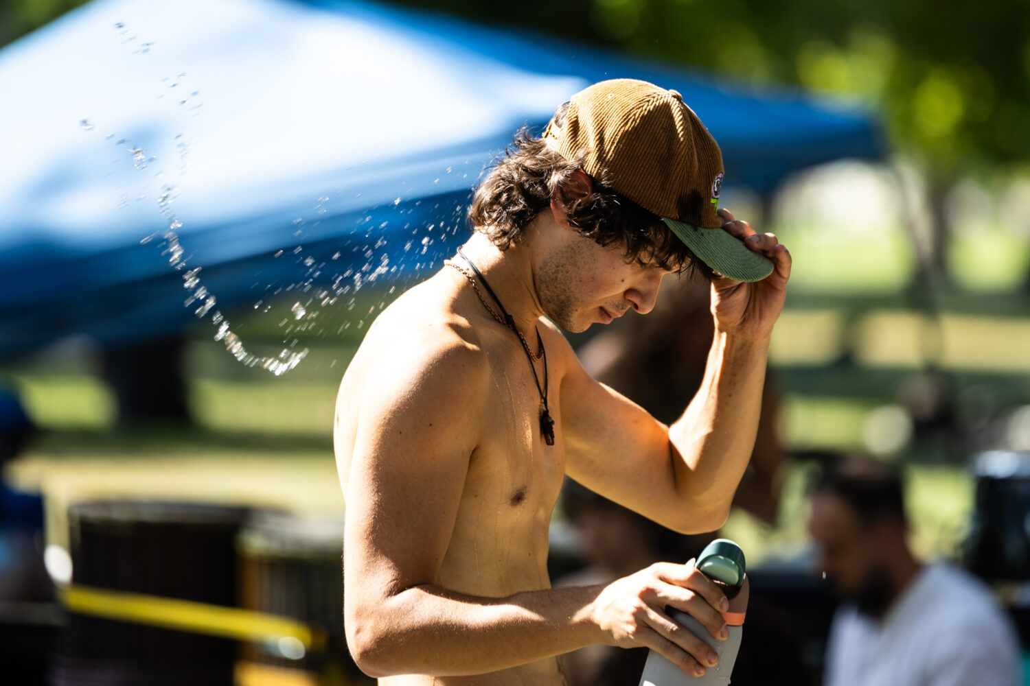 A man dumps a water-filled hat on his head during a city-wide heat advisory at Liberty Park in Salt Lake City on Sunday, July 26, 2026. Temperatures reached 103 degrees. (Lukas Katilius, Deseret News)