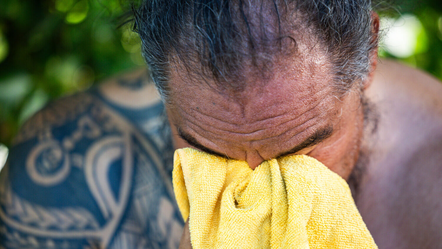 Hedley Fifita rubs his face with a towel while sitting in his front yard in the Fairpark neighborhood in Salt Lake City on Saturday, July 11, 2026. Doctors are reminding Utahns to stay alert as high temperatures continue. (Tess Crowley, Deseret News)
