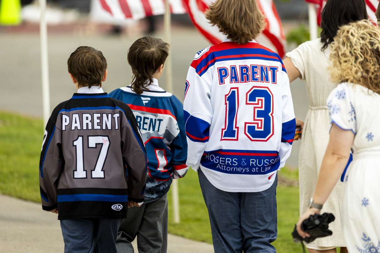 Kids sport hockey jerseys as they make their way toward the entrance with their families before the Long family funeral held at the UCCU Center in Orem on Wednesday. (Photo: Isaac Hale, Deseret News)