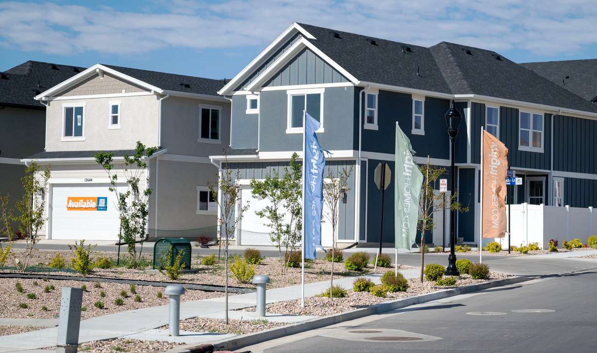 "Available" signs are seen in front of a model home in Herriman on May 12. (Photo: Scott G Winterton, Deseret News)
