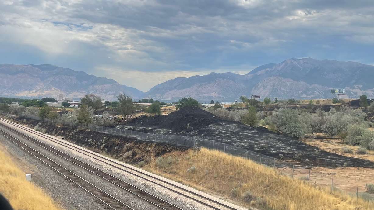 A day after the fire on Monday along a rail corridor shared by Utah Transit Authority and Union Pacific that torched three homes, debate lingers over the cause. One of the impacted areas west of Hinckley Drive is pictured on Tuesday. (Photo: Tim Vandenack, KSL)