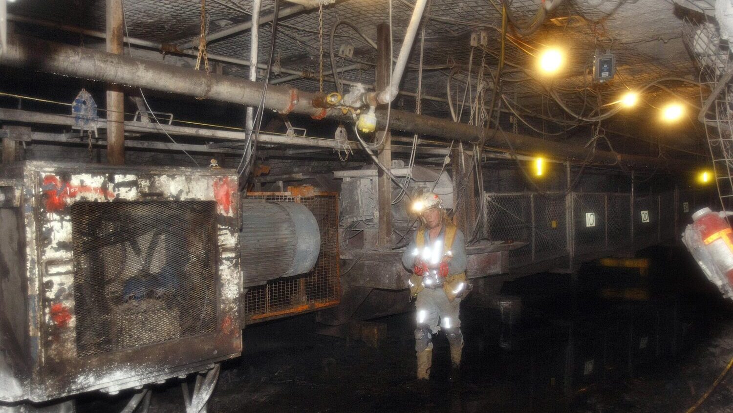 A coal miner inspecting a conveyor belt inside the Deer Creek Mine in Huntington, Utah, that is moving coal about 15 miles out of the mine to the surface and main entrance, where the coal is then broken down into smaller pieces and then moved down the canyon via a conveyor belt to the Huntington Power Plant and use to generate electricity. For story on how electricity is generated using coal. Thursday, Nov. 5, 2009 Stuart Johnson, Deseret News