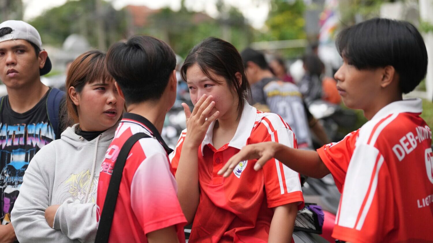 A schoolgirl cries outside her school where deaths and injuries were reported after a shooting in T...