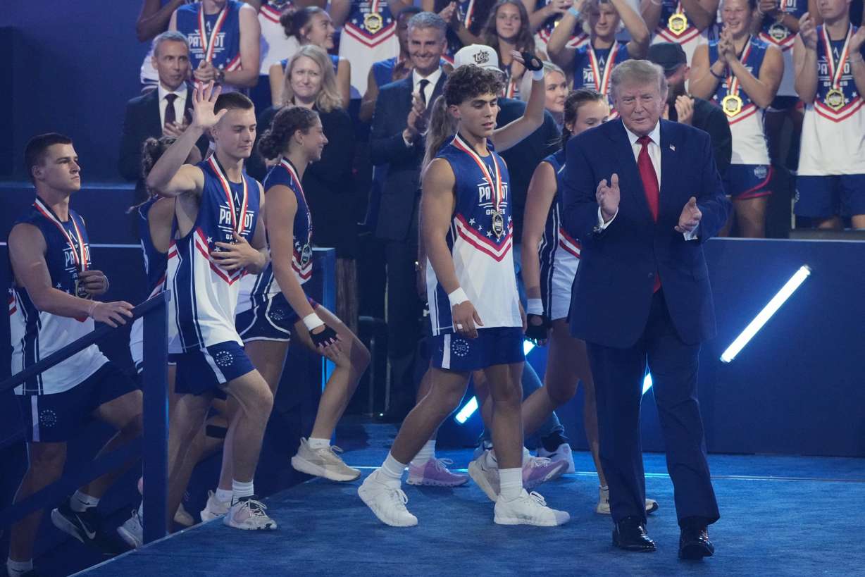 President Donald Trump walks onto stage with athletes at the Patriot Games at Spire Academy in Geneva, Ohio, on Tuesday. (Photo: Mark Schiefelbein, Associated Press)