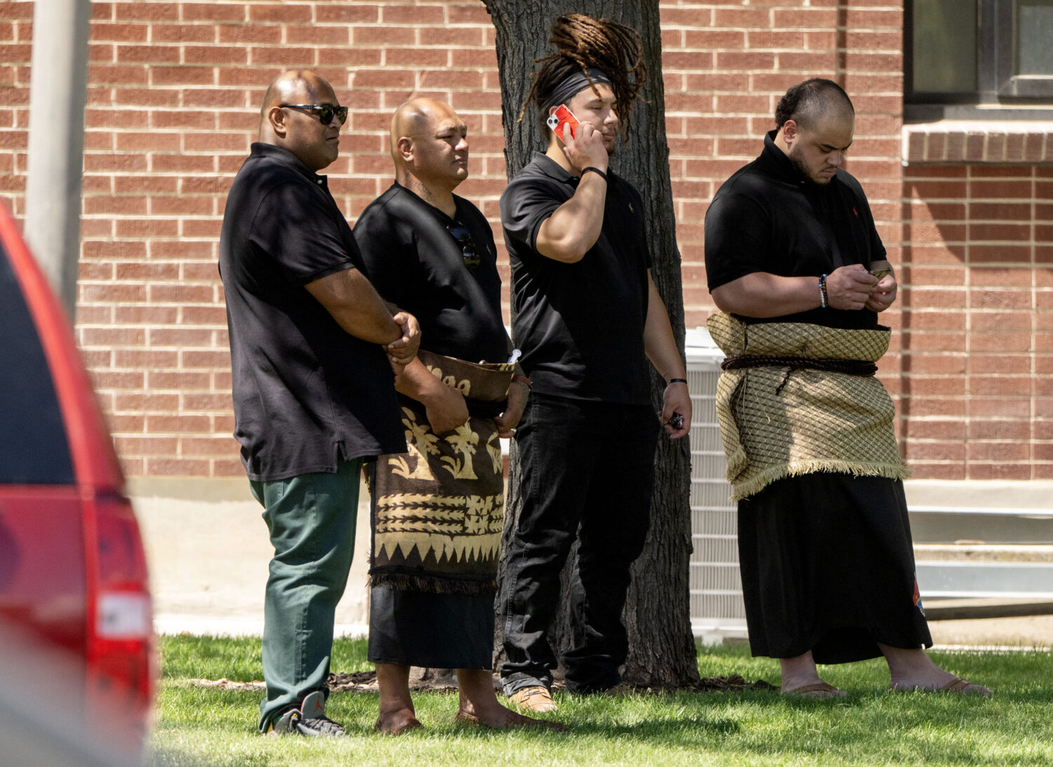 People stand and watch as police investigate a shooting that occurred in Kearns during a funeral on Monday, Aug. 17, 2026. (Scott G Winterton, Deseret News)