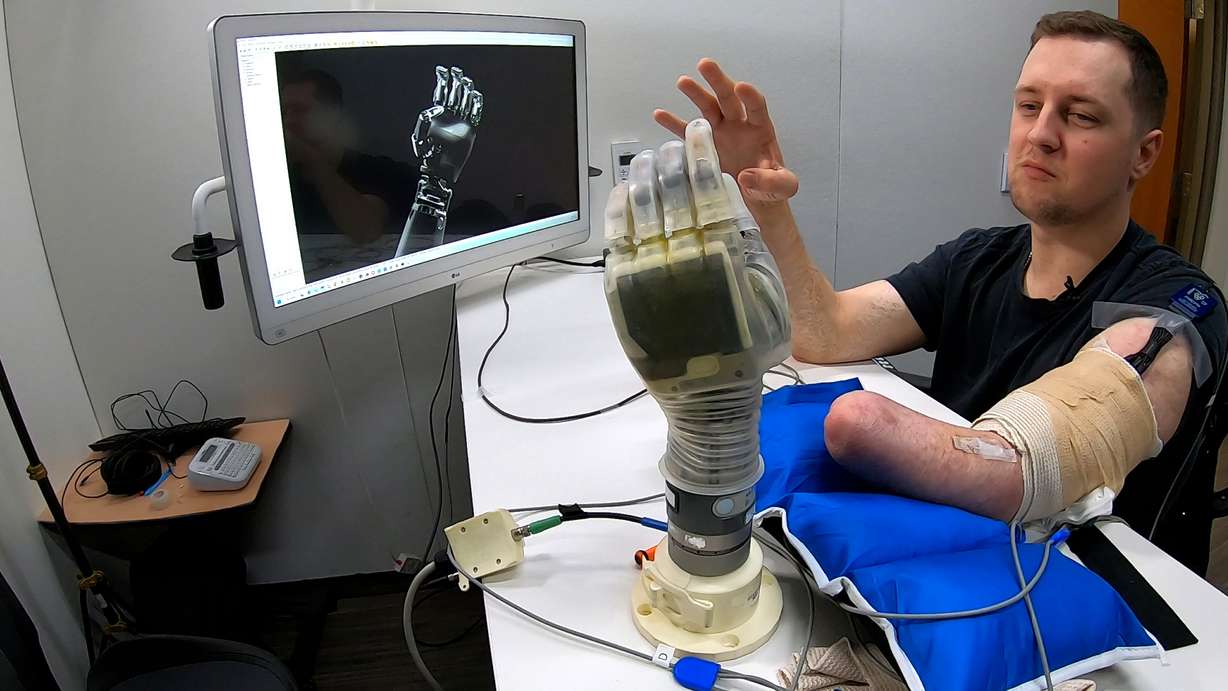Alexander "Avi" Davidson, a therapist from Tampa, Florida, trains AI software to understand how his brain communicates with his hand on Feb. 3. (Photo: Peter Rosen, KSL)