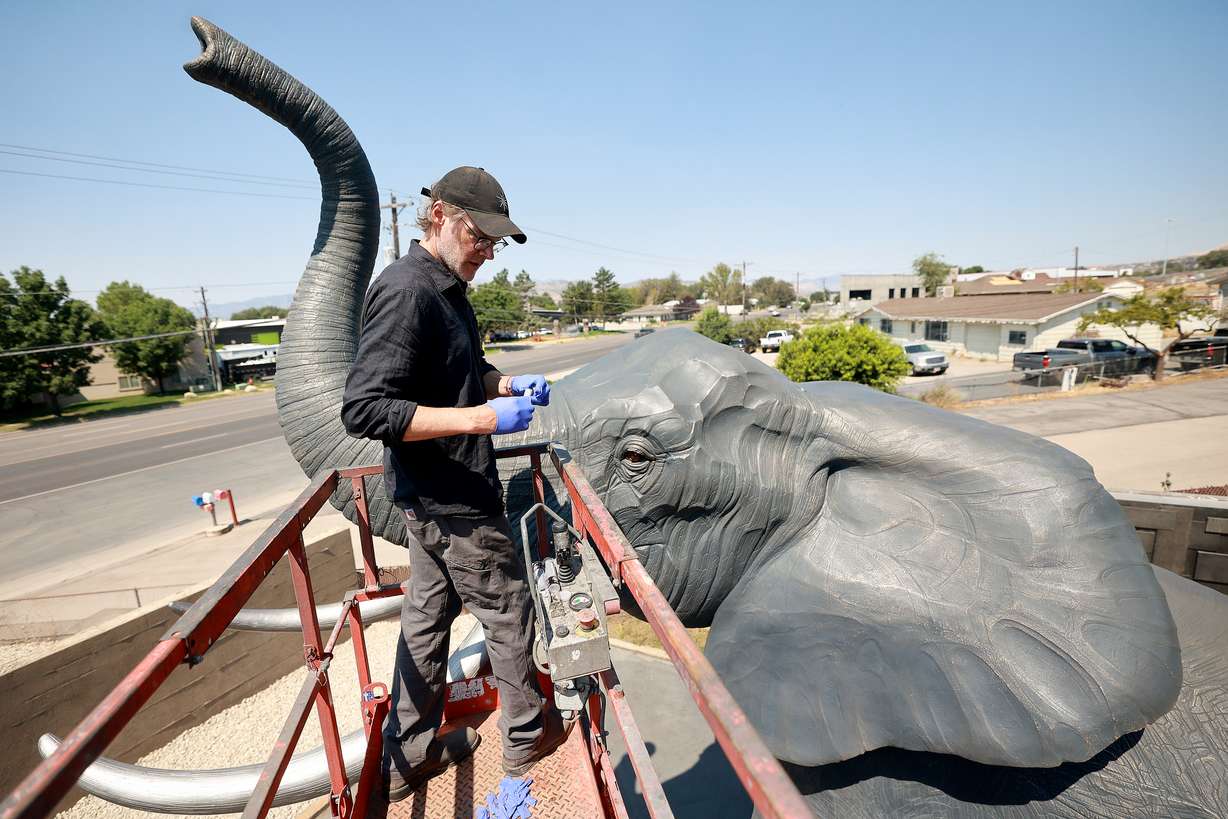 Matthew Gray Palmer makes a bullseye level which will be used to help transport and set up Yumi, a roughly 18,000-pound bronze elephant Palmer has been sculpting and building for seven years, at Metal Art Foundry in Lehi on Thursday. (Photo: Kristin Murphy, Deseret News)