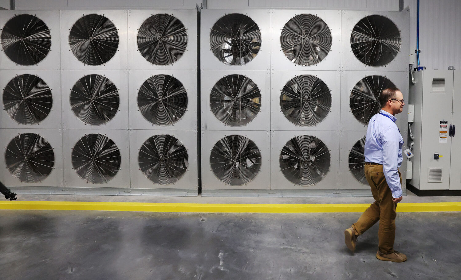 Data facilities manager Scott McLain walks past a fan wall used to cool servers used at Meta’s Eagle Mountain Data Center in Eagle Mountain on Friday, Sept. 30, 2022. Meta is expanding the data center, increasing the total investment to over $1.5 billion. Once completed, the center will be a 4.5-million-square-foot campus. (Jeffrey D. Allred, Deseret News)