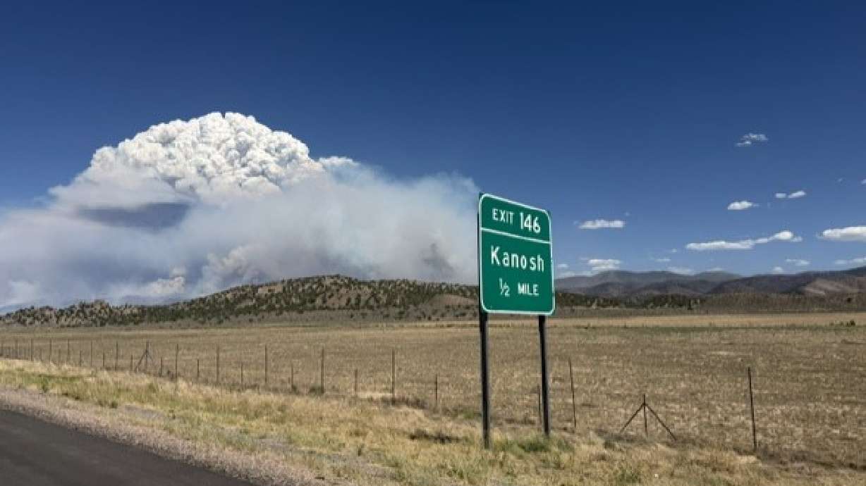 A large plume of smoke from the Widemouth 2 fire, outside of Kanosh, as seen from I-15 on Sunday at...