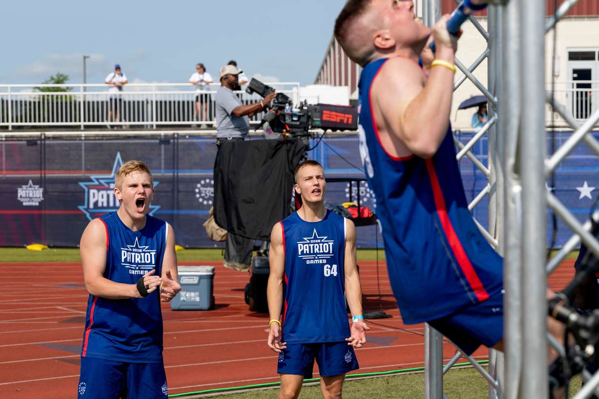 Utah's Rockwell Myers, middle, watches Gabriel Hayes of the Shawnee Tribe, right, cheers on other participants during day one of the Patriot Games, Sunday, in Geneva, Ohio. (Photo: Nate Manley, Associated Press)